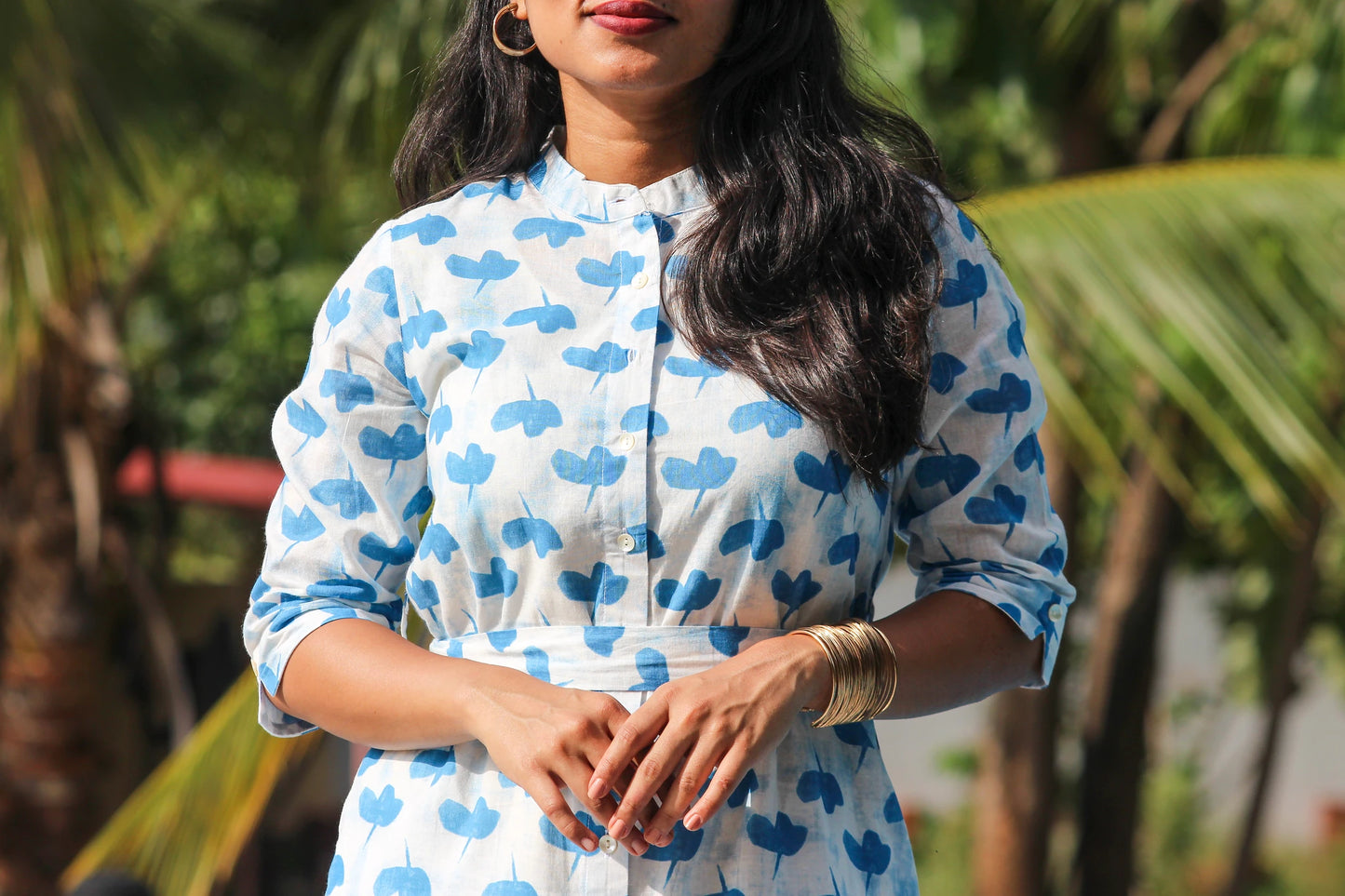 Model wearing the JUHU handblock printed cotton shirt dress with Mandarin collar and waist tie.