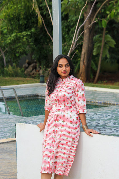 Bimba Studio Rose breathable cotton shirt dress featuring a floral print, functional pockets, and waist tie