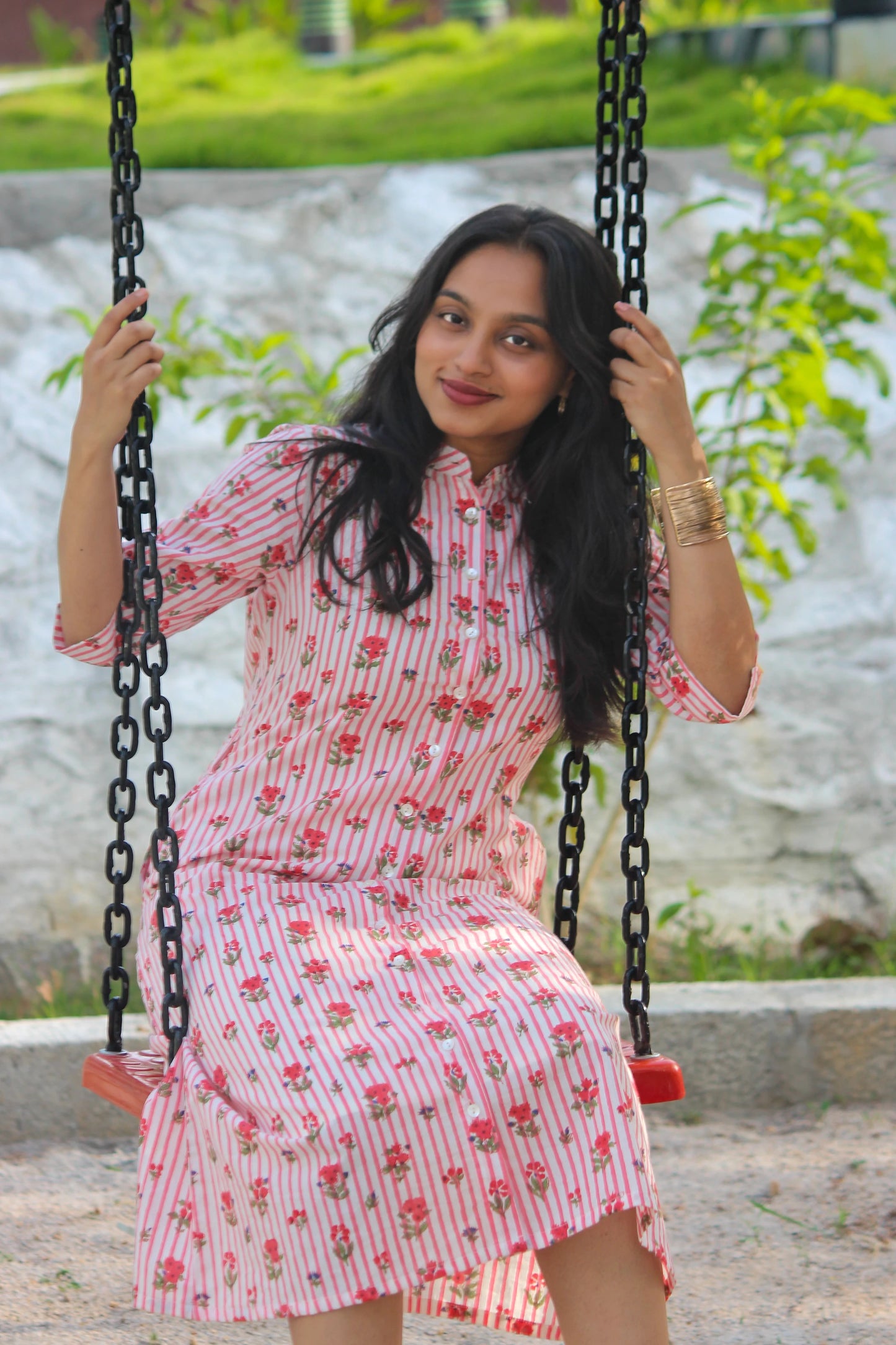 Bimba Studio Rose breathable cotton shirt dress featuring a floral print, functional pockets, and waist tie