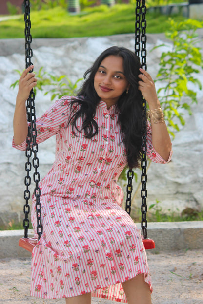 Bimba Studio Rose breathable cotton shirt dress featuring a floral print, functional pockets, and waist tie